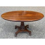 An early Victorian mahogany oval supper table, the top with beaded edge and raised on a turned and