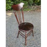 A Windsor type chair, possibly American, early 20th century, with circular 'penny' seat and shaped