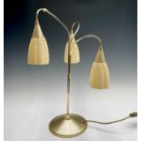 A mid century lacquered brass table lamp with three glass shades. Height 58cm.