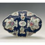 A Worcester porcelain dish, circa 1770, the blue scale ground with floral reserves, blue seal