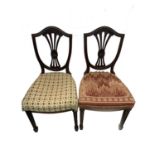 A set of four Edwardian mahogany Hepplewhite style dining chairs, with shield backs and