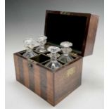 A satinwood and rosewood banded decanter box, early 19th century, containing four (of six) decanters