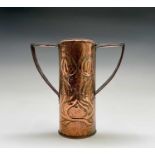 An Arts & Crafts period copper twin handled vase, the cylindrical body repousse decorated with