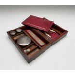 An early Victorian gentleman's mahogany campaign travel case, the interior fitted with jars, a