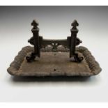 A Victorian cast iron boot scraper of Gothic form. Width 40cm.