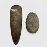 A Neolithic stone axe head, reputedly found in West Penwith, length 21cm, together with another