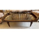 A mahogany and crossbanded coffee table, 20th century, with inset leather skiver, raised on