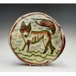 A Ben Fosker (b.1960) slip decorated earthenware plate painted with a fox. Diameter 24cm.