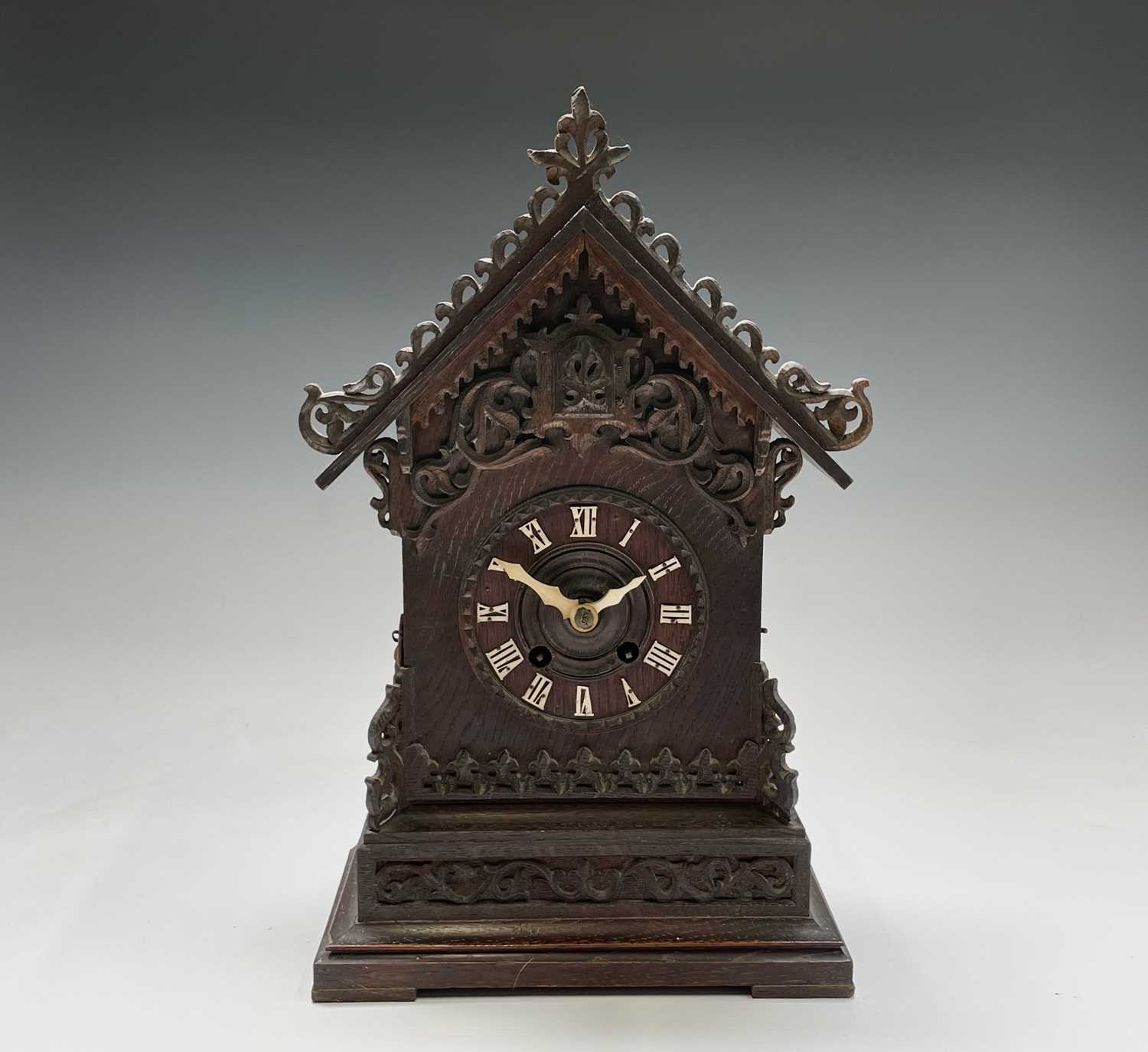 An oak and pine Black Forest cuckoo mantel clock, circa 1900, the case with carved and pierced