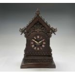 An oak and pine Black Forest cuckoo mantel clock, circa 1900, the case with carved and pierced