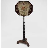 A Regency rosewood pole screen, with octagonal woolwork panel depicting an exotic bird amongst