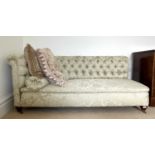 A late Victorian mahogany framed chaise lounge, upholstered in patterned green Sanderson fabric,