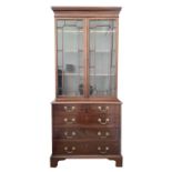 A mahogany bookcase cabinet, the upper part with glazed door enclosing three adjustable shelves, the
