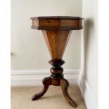 A Victorian walnut and inlaid octagonal work table, with fitted interior and raised on a carved