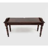 A Victorian mahogany hall bench, raised on turned legs. Height 47cm, width 91cm, depth 33cm.