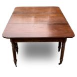 A Regency mahogany extending dining table, with two D ends and an additional leaf, raised on
