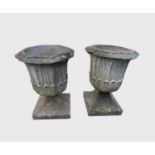 A pair of reconstituted stone garden urns of octagonal form. Height 56cm.