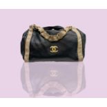 Chanel. Vintage bag, Olsen model. Black lambskin with contrasting beige lambskin and chain