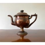 A William IV copper teapot, with semi-gadrooned cover, pearwood handle on circular foot, height