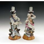 A pair of Helena Wolfsohn porcelain candlestick figures, modelled as a shepherd and his companion