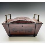 A Regency mahogany and ebony inlaid box, of sarcophagus shape with slightly domed lid and raised