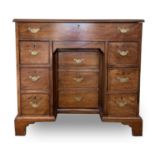 A George III mahogany kneehole gentleman's dressing chest, the rising top containing compartments