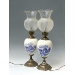 A pair of 20th century gilt metal mounted Delft table lamps with glass shades. Height 60.5cm.