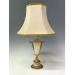 An ornate alabaster table lamp, early 20th century, with gilt metal mask handles and mounts,
