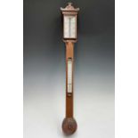 A Victorian walnut stick barometer, by J Hicks, London, with ivory scales, twin vernier indicators
