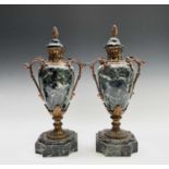 A pair of French ormolu mounted green marble urns and covers, in the Louis XV style, circa 1900, the
