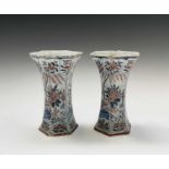 A pair of Dutch Delft polychrome vases, 18th century, of hexagonal tapered form, painted in the