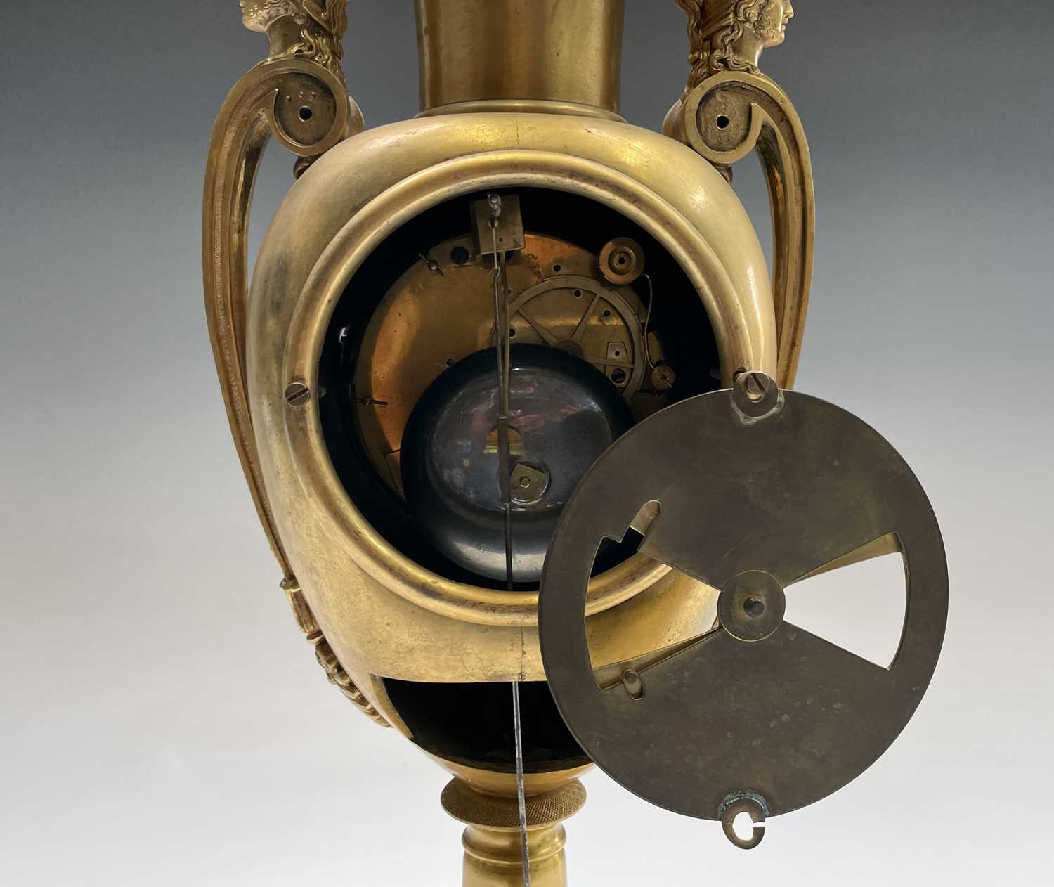 A French Empire ormolu cased mantel clock, of urn form, the covered rim applied with two winged - Image 7 of 12