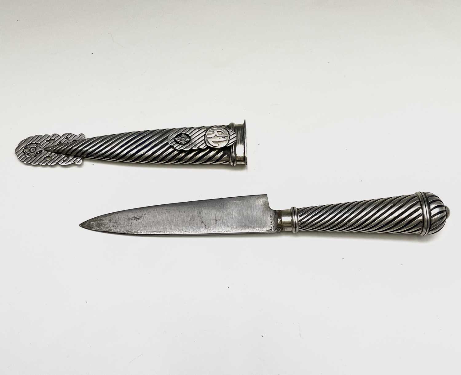 An Argentinian gaucho knife, mid 20th century, with spiral white metal grip and similarly