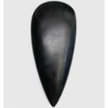 A Neolithic style polished stone axe head, length 16cm, width 7cm.