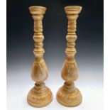 A pair of large gold painted candle stands. Height 64cm.