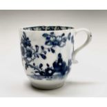 A Lowestoft blue and white porcelain coffee cup, circa 1780, painted with a rock, flowering peony