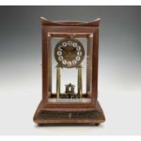 A walnut cased 400 day torsion clock, circa 1920, the brass framed circular copper dial with blue