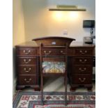 An Edwardian mahogany twin pedestal writing desk, with tooled leather skiver, and fitted with an