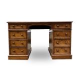 A Victorian oak desk, stamped Taylor, Fisher & Blunt, 110 Fenchurch St, London, with eight