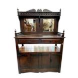 An Arts and Crafts oak mirror backed sideboard, height 153cm, width 104cm, depth 45cm.