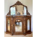 A Victorian walnut chiffonier with shaped carved frame mirror back above a white marbled top and