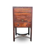 An early George III mahogany washstand, the divided folding top opening to reveal spaces for a