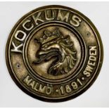 A Swedish brass ship builder's plaque, inscribed Kockums Malmo 1891, diameter 29.5cm.