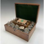 A Victorian oak cased family medicine chest, fitted with an assortment of glass jars and stoppers,