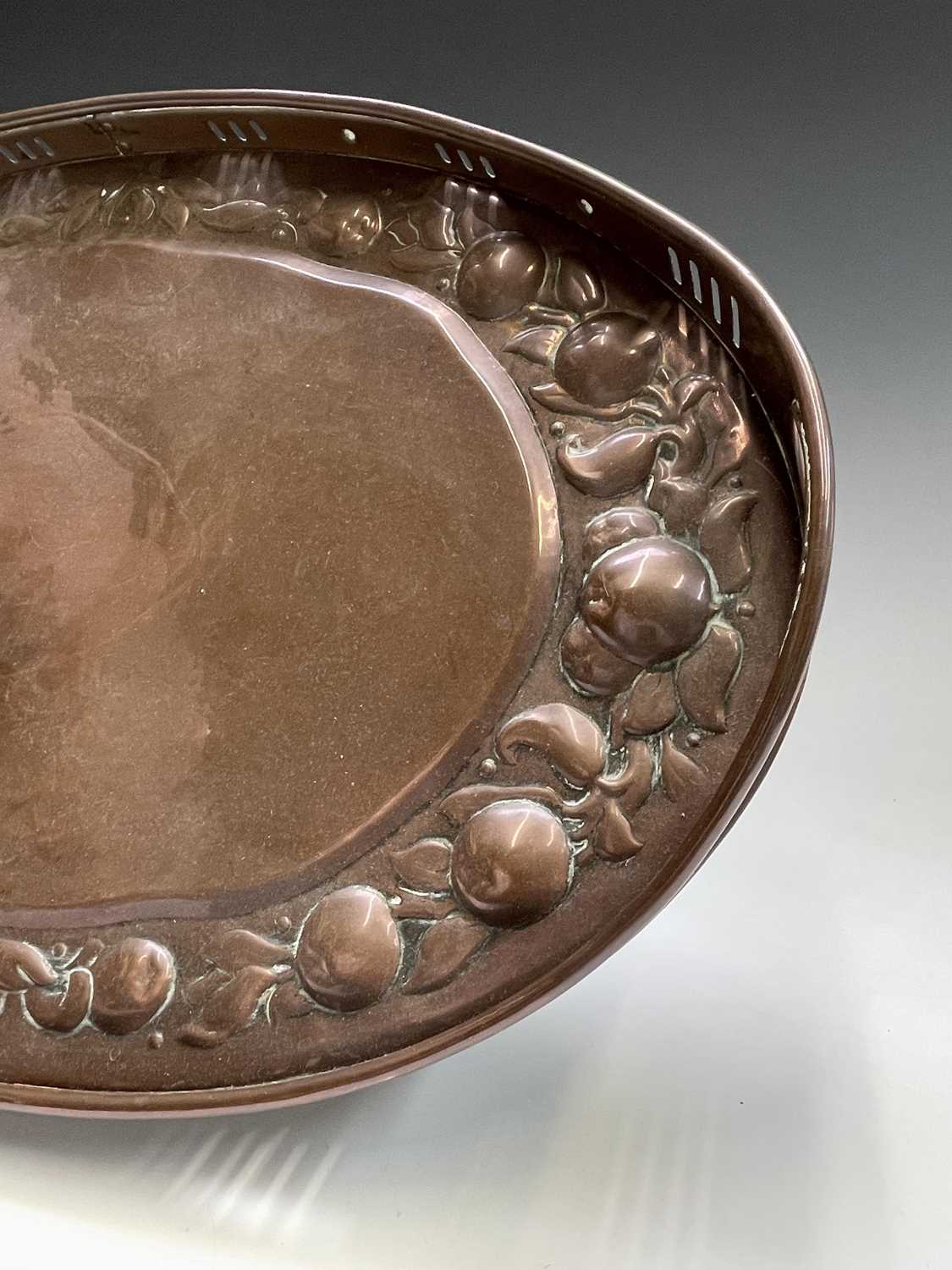 A Newlyn copper oval tray, circa 1910, the raised edge with twin handles, the border repousse - Image 4 of 8
