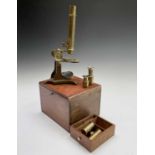 A late Victorian brass microscope, with lenses, contained in a mahogany case with fitted drawer,