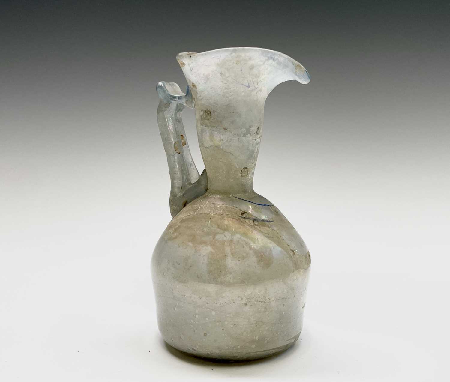 Three iridescent glass vessels, possibly Roman, comprising a ewer, height 13cm, and two vases. - Image 6 of 16
