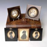 A mid-19th century silhouette portrait of a gentleman, heightened in gilt and white, 6.5X5.5cm,