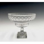 A Georgian cut glass pedestal bowl, with serrated rim, hobnail cut lozenges and lemon squeezer base,