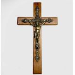 A mid century oak mounted cast brass wall hanging crucifix. Overall height 47.5cm.